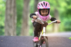 How does the patented power system assist children in learning to balance and ride a bike?